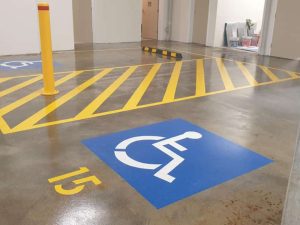Car park with wheelstops, bollards, height safety bars, bike racks and concrete sealing.
